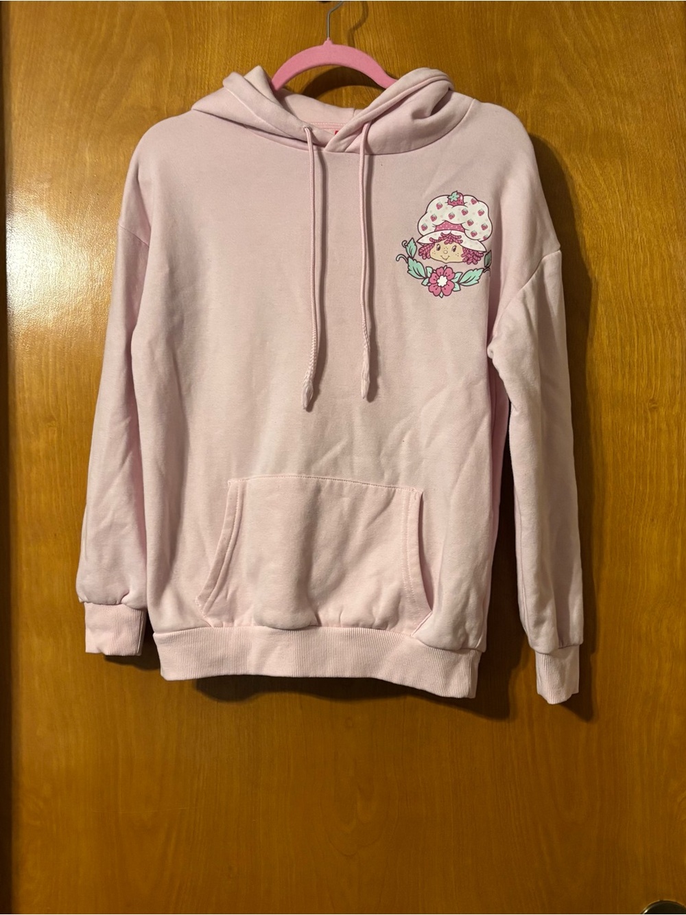 Soft Pastel Pink Graphic Hoodie with Floral Character